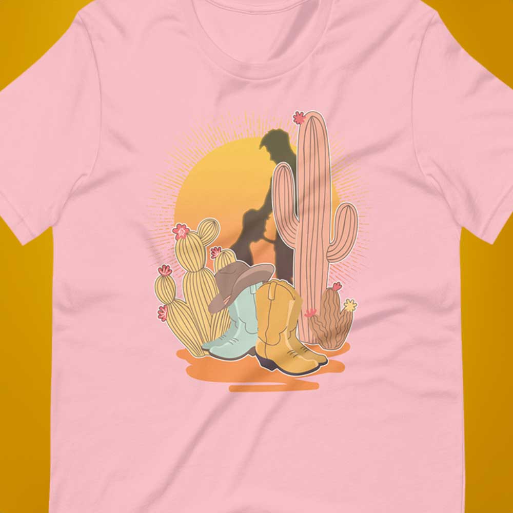 Pink shirt featuring a sunset with two silhouetted figures, one sitting sucking the one standing, surrounded by cacti - Vintage Brokeback Cowboy t-shirt - western gay pride tee by BackRoom Gear
