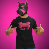 Person wearing a black t-shirt with a pink bone design and 'CHEW TOY' text, pointing at the shirt against a pink background.