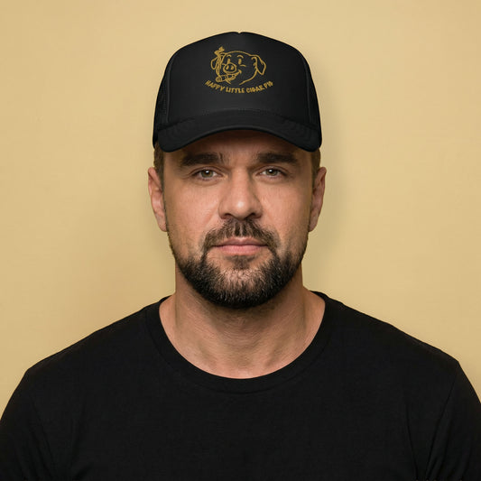 Gay man wearing Happy Little Cigar Pig trucker cap with cartoon pig smoking cigar graphic on black mesh snapback hat - Backroom Gear