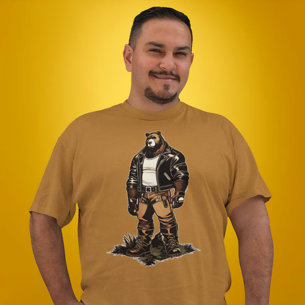 Gay bear wearing a toast brown t-shirt with a graphic of a buff cartoon bear wearing a leather jacket - Leather Daddy Bear T-Shirt – Gay Bear Pride Community Tee – LGBTQ+ pride t-shirts US UK – Gay pride shirts collection – Made-to-order gay apparel