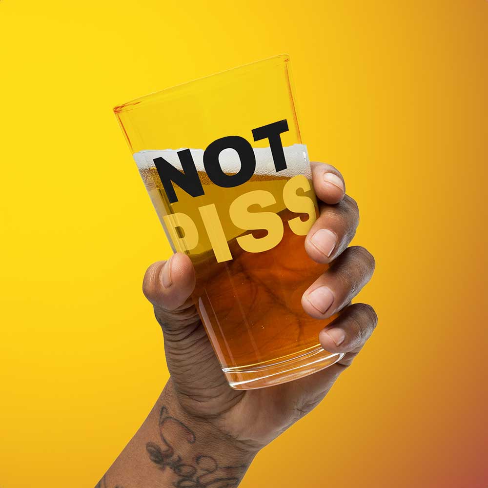 hand holding a half full NOT PISS pint glass - watersports kink pride LGBTQ+ glass by BackRoomGear