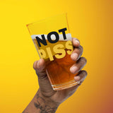 hand holding a half full NOT PISS pint glass - watersports kink pride LGBTQ+ glass by BackRoomGear