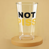 A pint glass with the text 'NOT PISS' printed on it, filled with a beverage, presented against a beige background NOT PISS pint glass - watersports kink pride LGBTQ+ glass by BackRoomGear