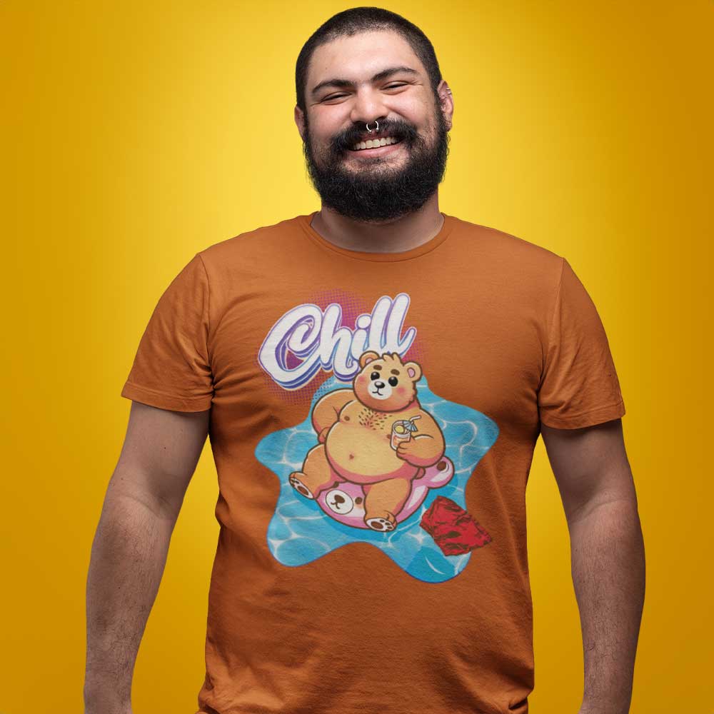 Gay bear wearing a autumn orange t-shirt with a pool bear graphic and 'Chill' text on a yellow background - Bear Pool Pride T-Shirt | Chubby Bear Graphic Tee – Gay pride shirts collection – LGBTQ+ pride t-shirts US UK – Made-to-order gay apparel