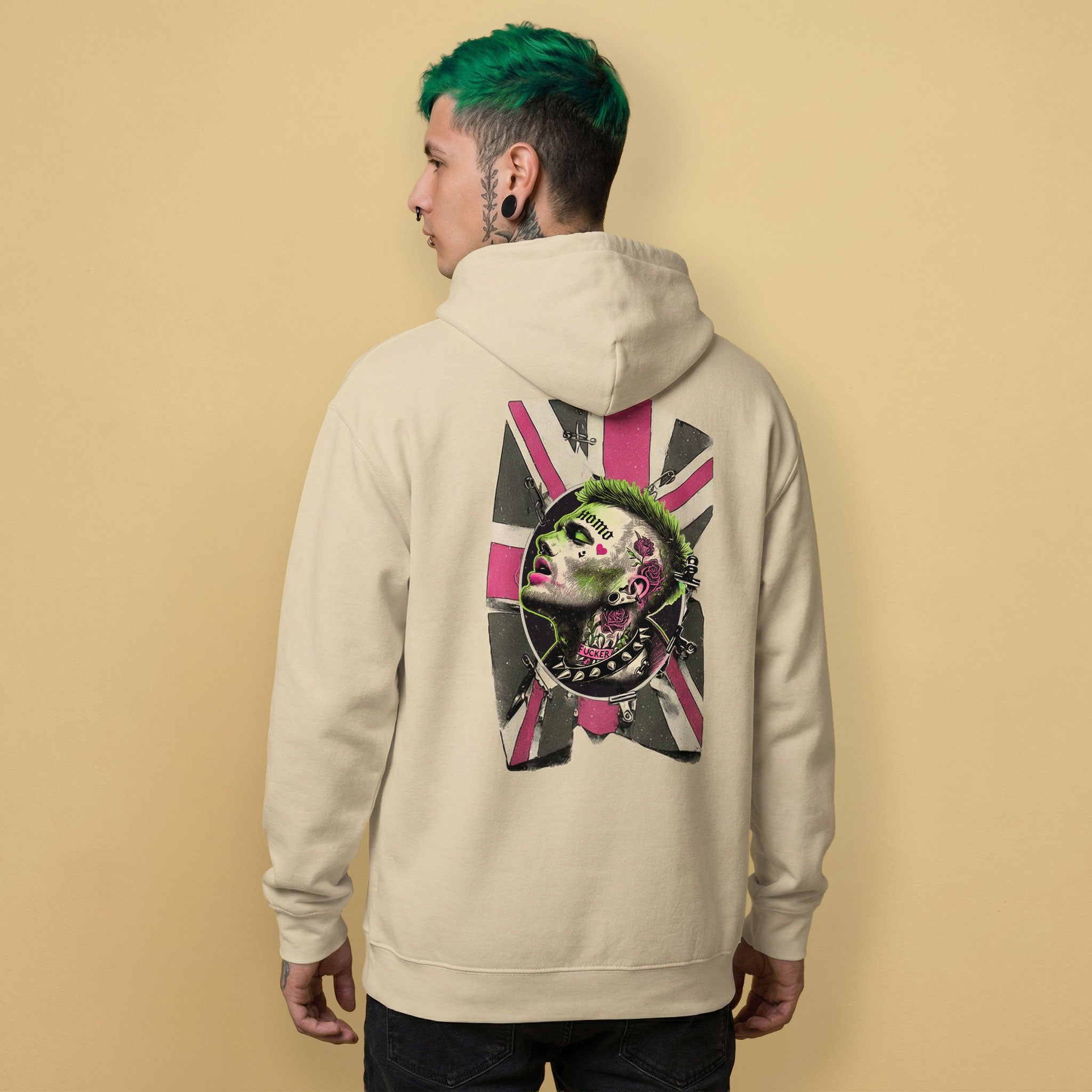gay man wearing a beige hoodie with a unique homosexual pink & green punk design with the union jack on the back against a beige background - Sand Queer Punk Anthem hoodie - gay rebel pride LGBTQ+ pullover by BackRoomGear