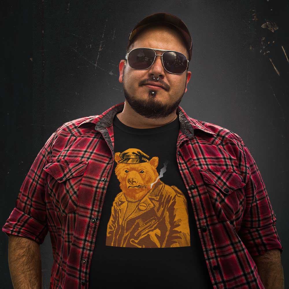 Gay bear wearing Retro Leather Bear Black T-shirt with a vintage-style graphic of a leather-clad bear, sunglasses, and a red plaid shirt - Vintage Leather Bear Pride T-Shirt – Retro Gay Bear Flag Tee – LGBTQ+ pride t-shirts US UK – Gay pride shirts collection – Made-to-order gay apparel