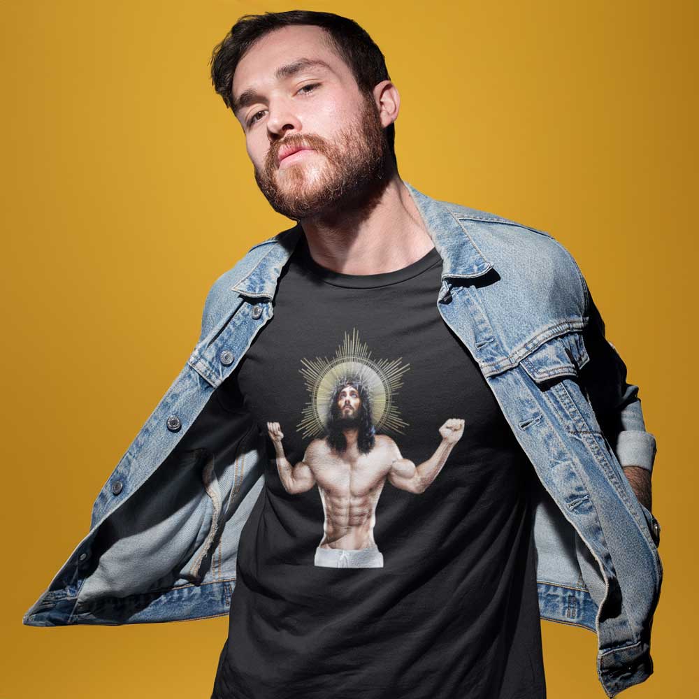 Gay Man wearing a Black shirt featuring a graphic of a black Jesus with a muscled body and six pack looking up to heaven. - Black Ripped Saviour gay religious t-shirt - LGBTQ+ pride apparel by BackRoomGear
