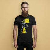 gay Man wearing a black t-shirt with a man in rubber with yellow helmet and shoes sitting on top of a square barrel of piss graphic design on a beige background - Black and yellow Sexy Rubber Flanders t-shirt - kinky latex rubber kink tee by BackRoomGear