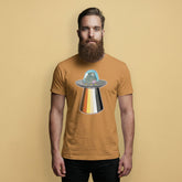Gay Bear wearing a toast brown t-shirt with a Bear Pride flag UFO on a beige background - UFO Bear T-Shirt – Gay Leather Pride Tee for Bears – LGBTQ+ pride t-shirts US UK – Gay pride shirts collection – Made-to-order gay apparel