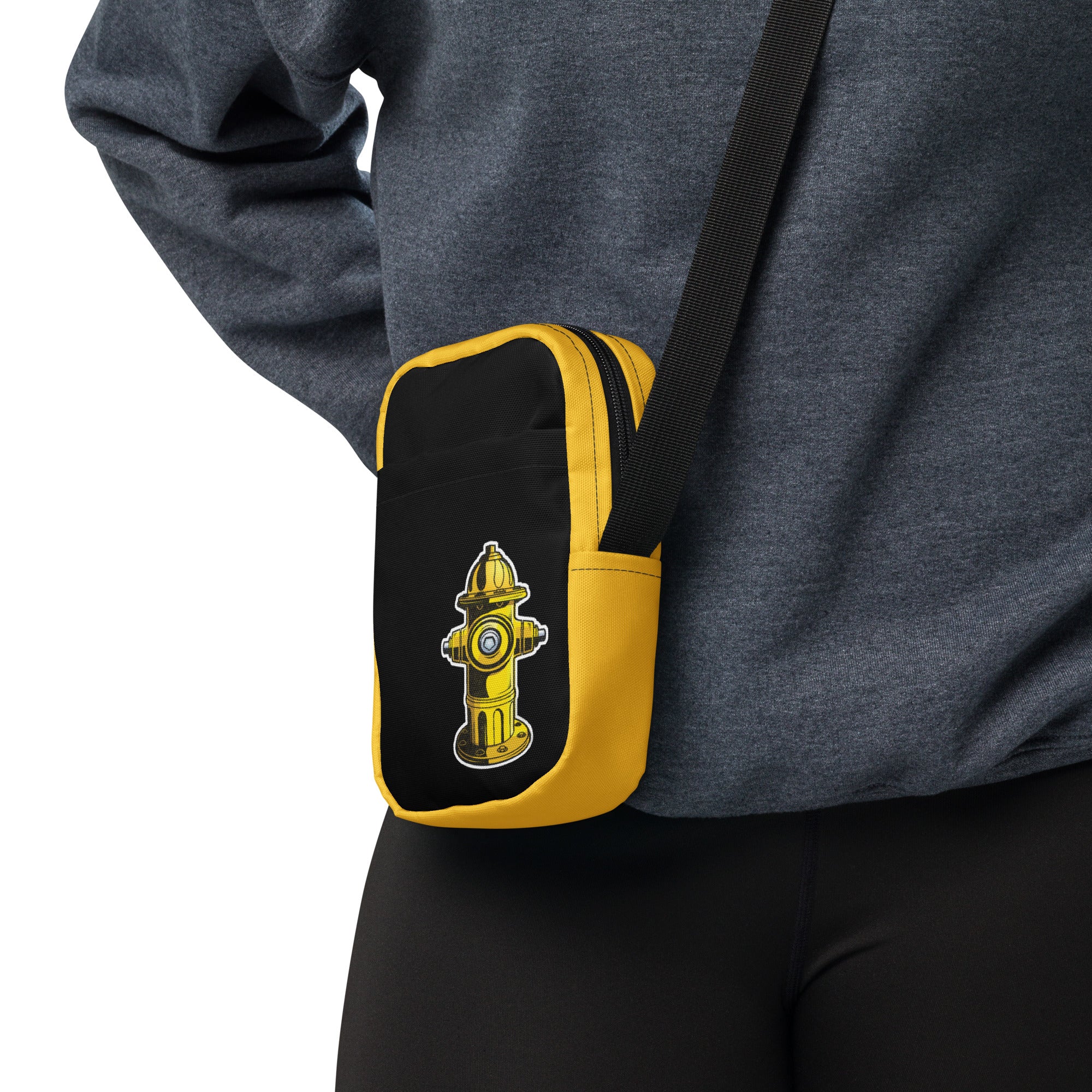 A black and yellow crossbody bag with a watersports hydrant design, featuring multiple pockets and an adjustable shoulder strap. Hydrant Party Essentials crossbody bag - gay pup circuit party bag by BackRoom Gear