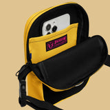 A black and yellow crossbody bag with a watersports hydrant design, featuring multiple pockets and an adjustable shoulder strap. Hydrant Party Essentials crossbody bag - gay pup circuit party bag by BackRoom Gear