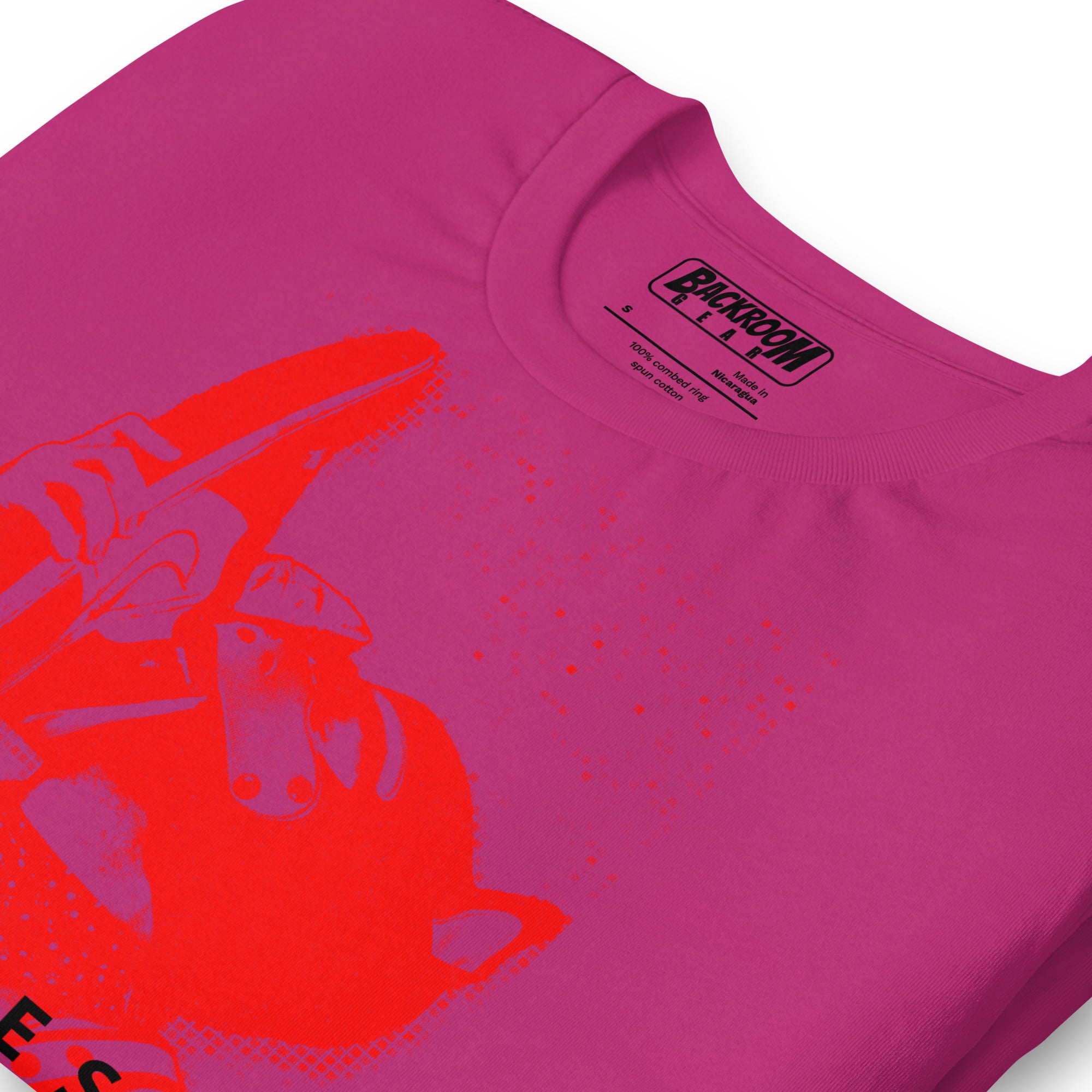 Folded closeup of berry pink t-shirt with a Sneaker Pup graphic design and 'CONFESS' text