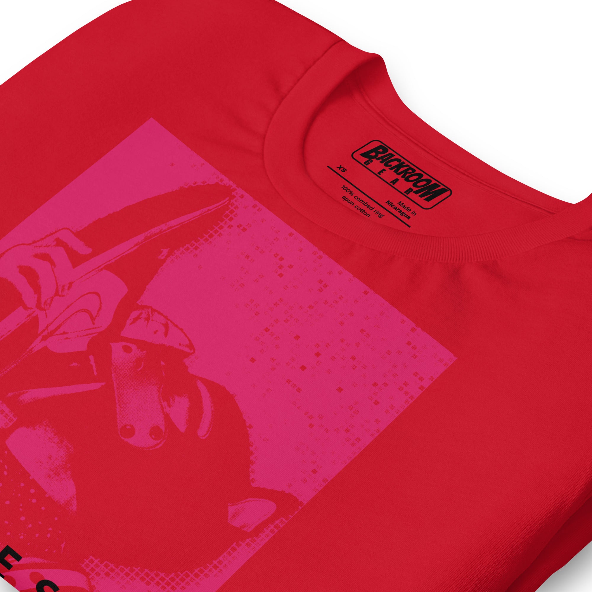 Folded closeup of red t-shirt with a Sneaker Pup graphic design and 'CONFESS' text