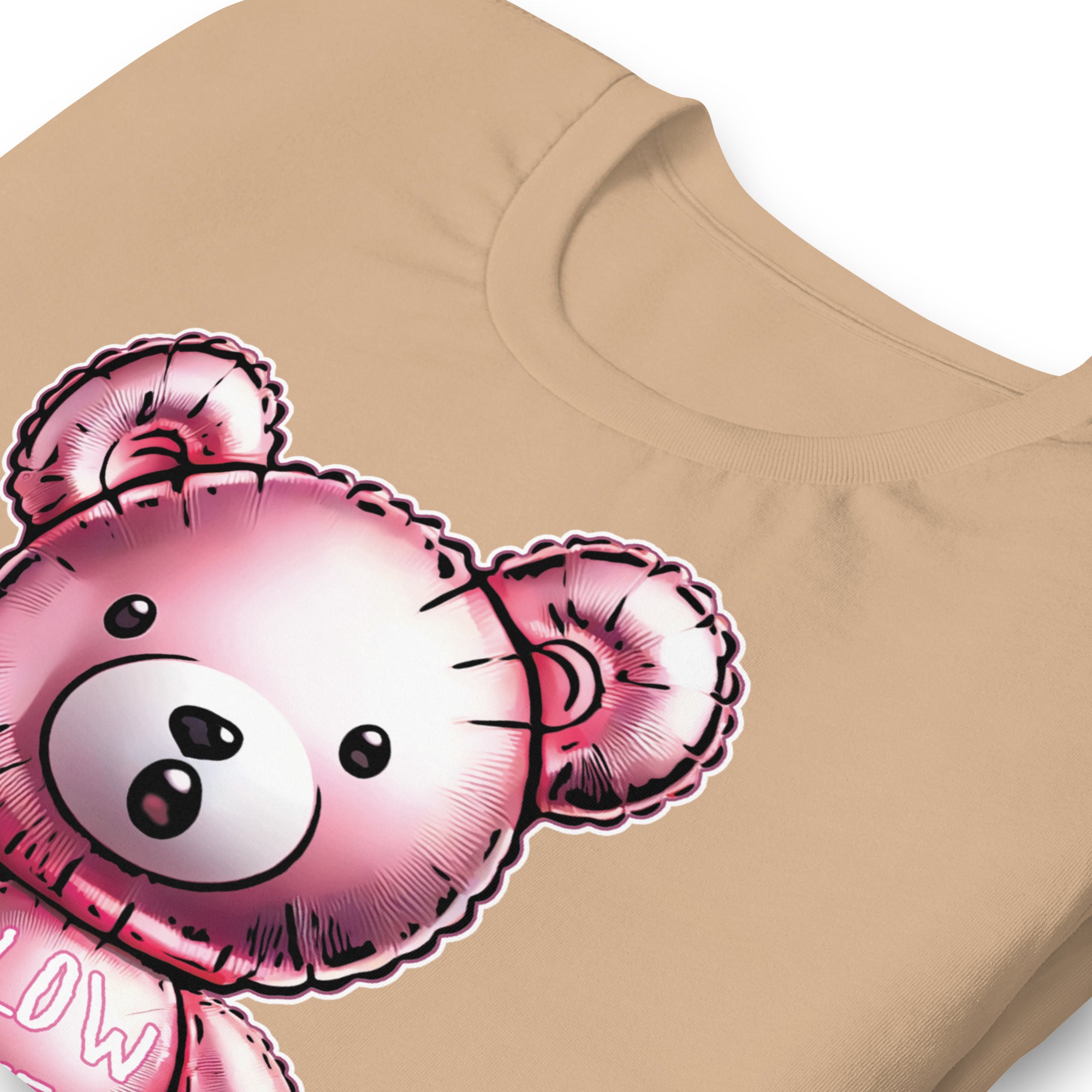 Folded Tan t-shirt with a bear balloon design with the words "BLOW ME" on a beige background - Berry pink Blow Me Bear t-shirt - funny gay pride balloon tee by BackRoom Gear