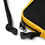 Clip detail of A black and yellow crossbody bag with a watersports hydrant design, featuring multiple pockets and an adjustable shoulder strap. Hydrant Party Essentials crossbody bag - gay pup circuit party bag by BackRoom Gear