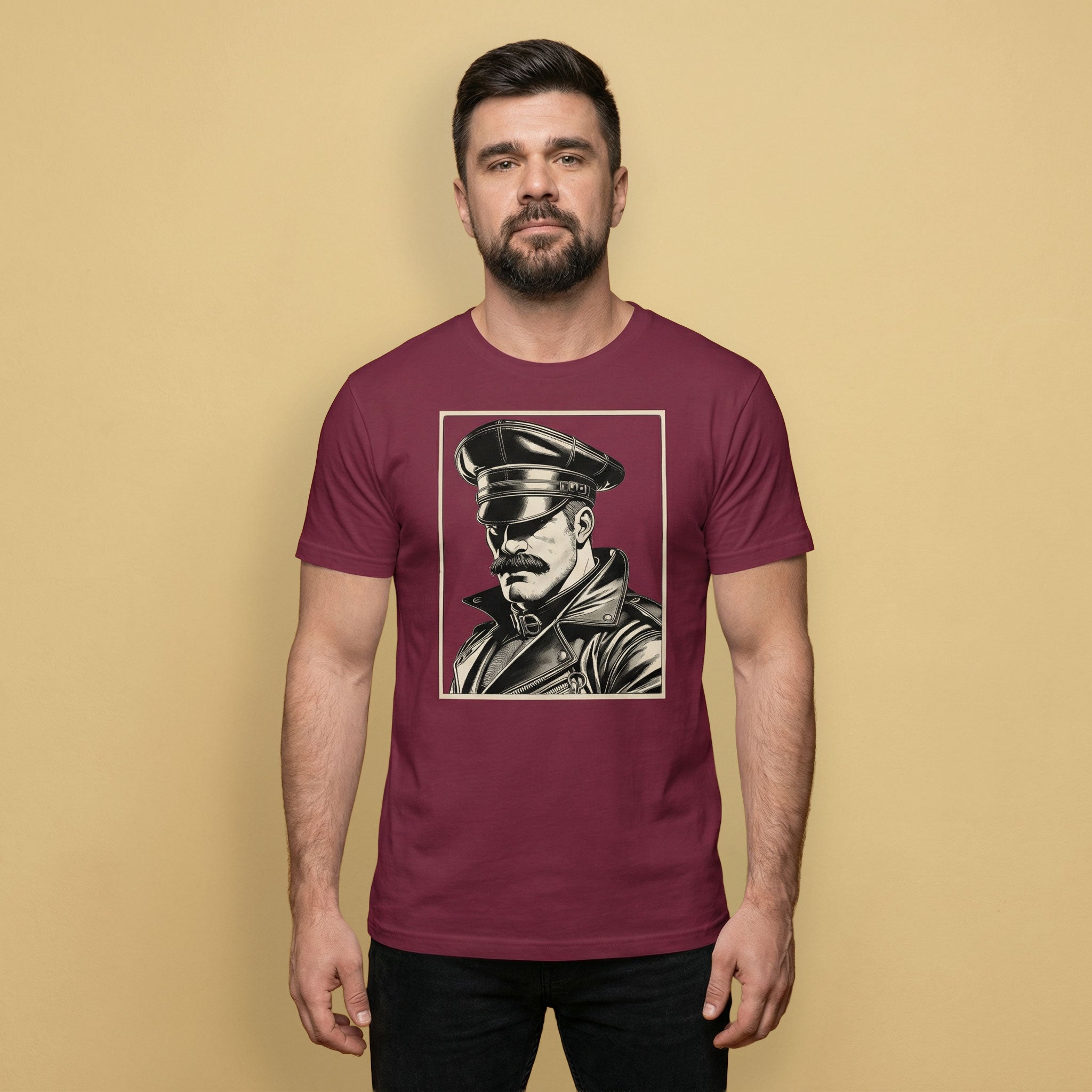 Gay Man wearing a maroon t-shirt with a graphic of a Leather Daddy portrait on a beige background- Maroon Leather Icon t-shirt - leather daddy gay pride LGBTQ+ tee by BackRoomGear