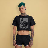 Man wearing a Confess Crop Sniff Test, black gay crop top with pup graphic, standing against a beige background