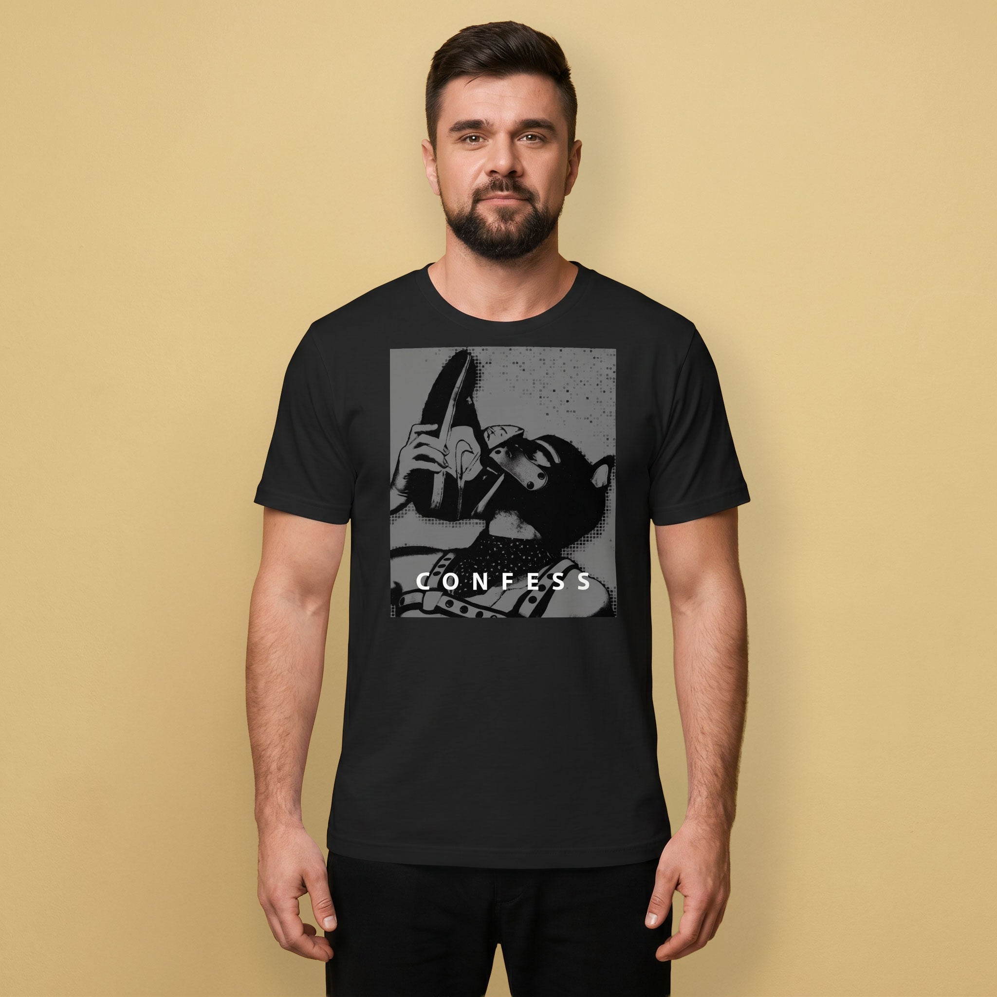 A gay man wearing a black t-shirt with a Sneaker Pup graphic design and 'CONFESS' text
