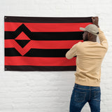 Person hanging a Fisting Kink Pride Flag, showcasing bold red and black design, representing kink pride.