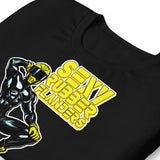 Folded black t-shirt with a man in rubber with yellow helmet and shoes sitting on top of a square barrel of piss graphic design on a beige background  - Black and yellow Sexy Rubber Flanders t-shirt - kinky latex rubber kink tee by BackRoomGear