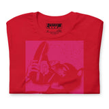 Folded closeup of red t-shirt with a Sneaker Pup graphic design and 'CONFESS' text