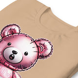 Folded Tan t-shirt with a bear balloon design with the words "BLOW ME" on a beige background - Berry pink Blow Me Bear t-shirt - funny gay pride balloon tee by BackRoom Gear