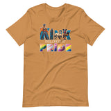 Toast brown t-shirt with graphic text and colorful elements related to the LGBTQ+ and kink communities. Kink Belongs at Pride T-Shirt – Bold LGBTQ+ Kink Pride Tee – Gay pride shirts collection – LGBTQ+ pride t-shirts US UK – Made-to-order gay apparel