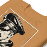 Folded toast brown T-shirt with a graphic design of a mustachioed man in classic leather gear - - Brown Leather Icon t-shirt - leather daddy gay pride LGBTQ+ tee by BackRoom Gear